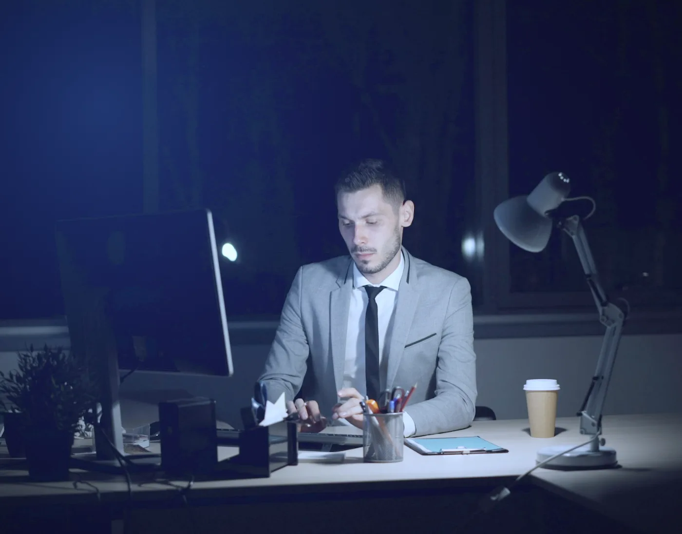 Advisor working late at his office desk